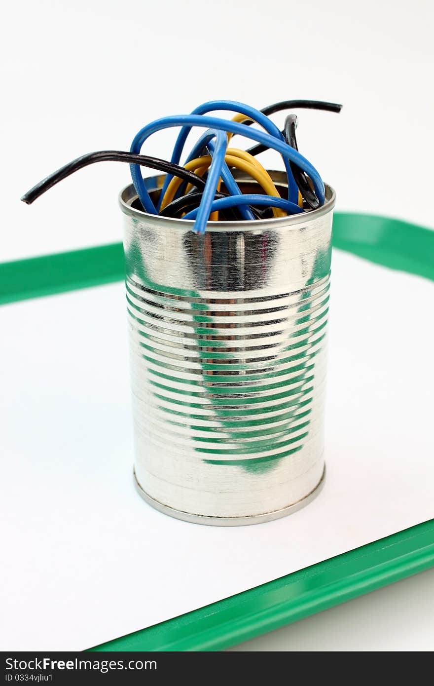 Roll of wire into a metal tin. Roll of wire into a metal tin