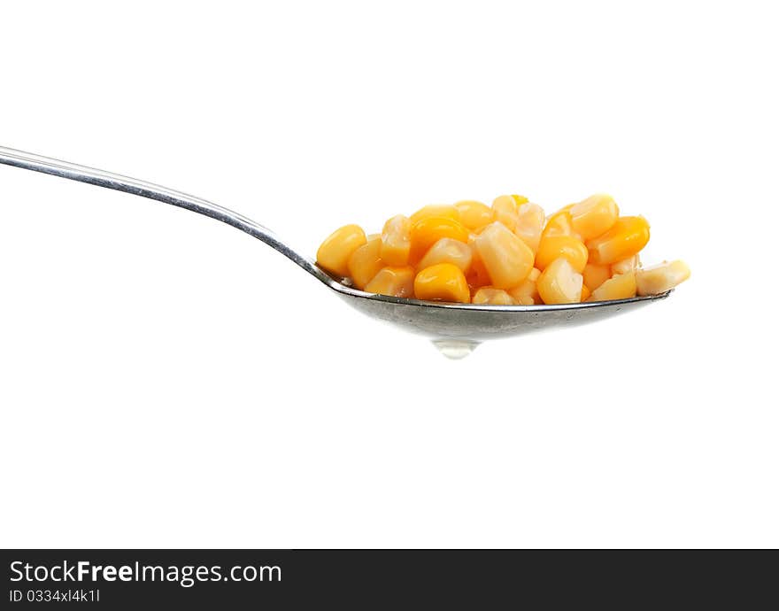 Spoon with corn on a white background