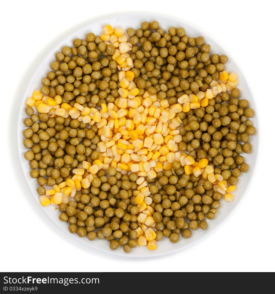 Corn and peas on a plate on a white background