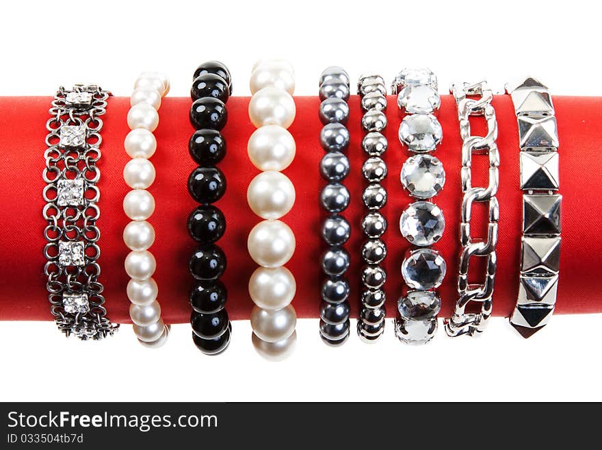 Women's bracelets on the red hat on a white background