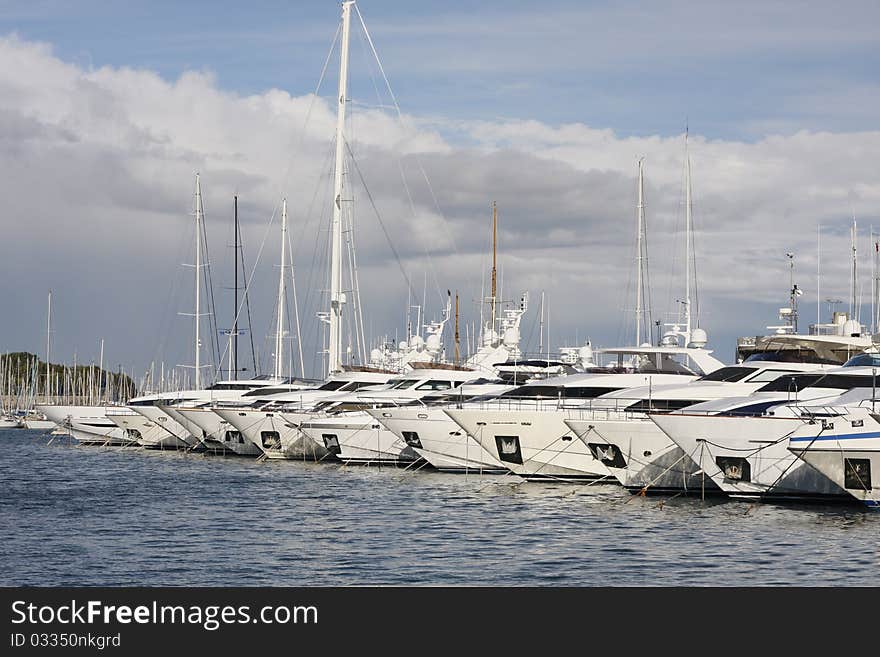 Yachts in the harbour on the sunny day.