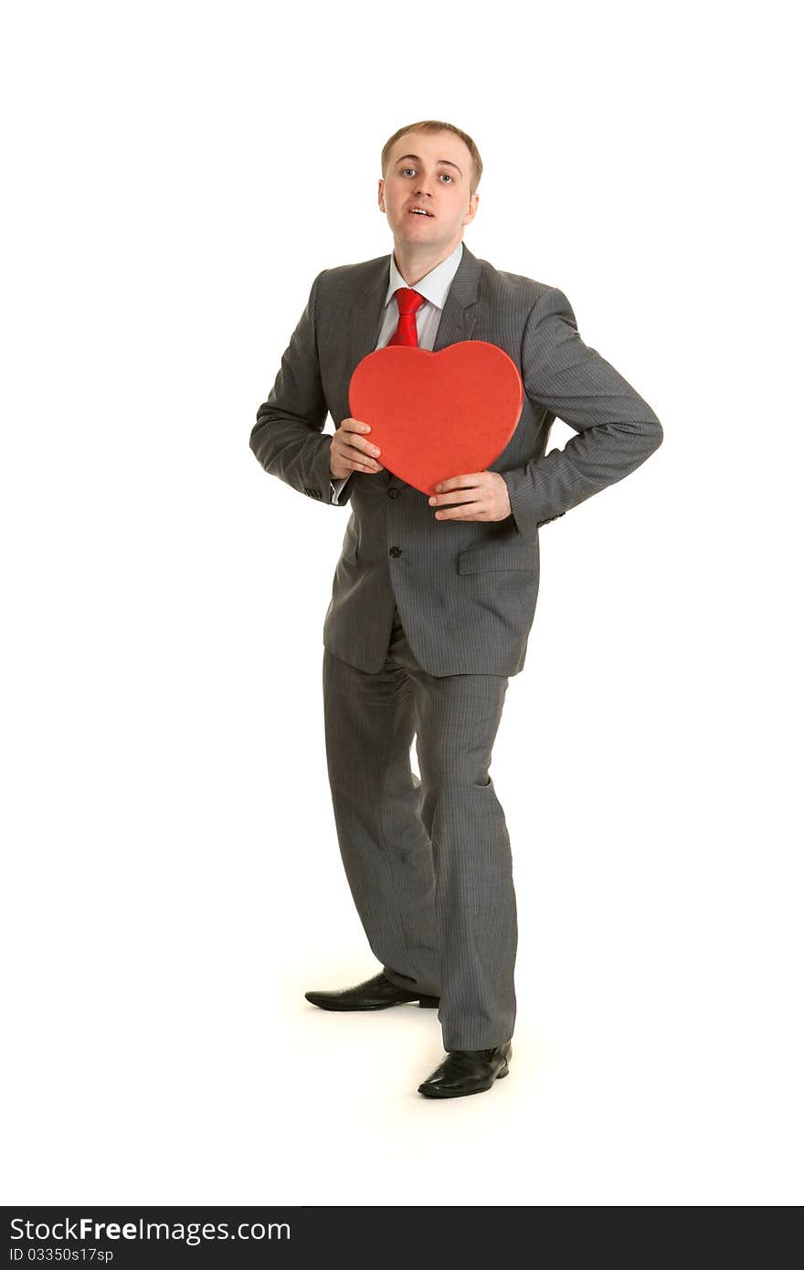 Man in gray suit and tie keeps in hand decorative red heart