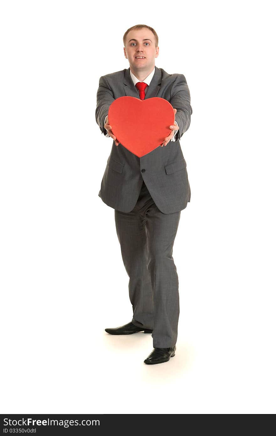 Man in gray suit and tie keeps in hand decorative red heart