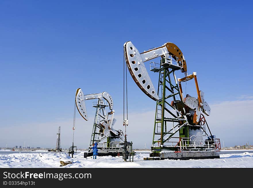 Cold winter, oil producing equipment is covered with snow. Cold winter, oil producing equipment is covered with snow