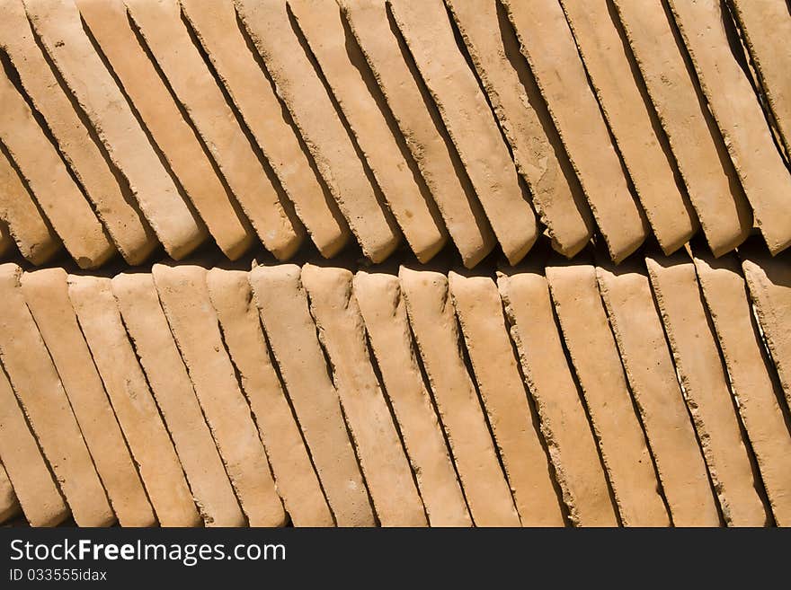 Clay garden sandstone paving brick tile slabs in earth colors stacked in bulk. Clay garden sandstone paving brick tile slabs in earth colors stacked in bulk