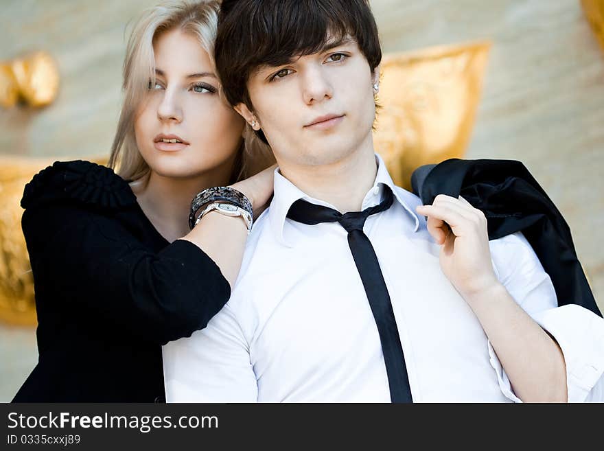 Couple - girl and guy near the wall