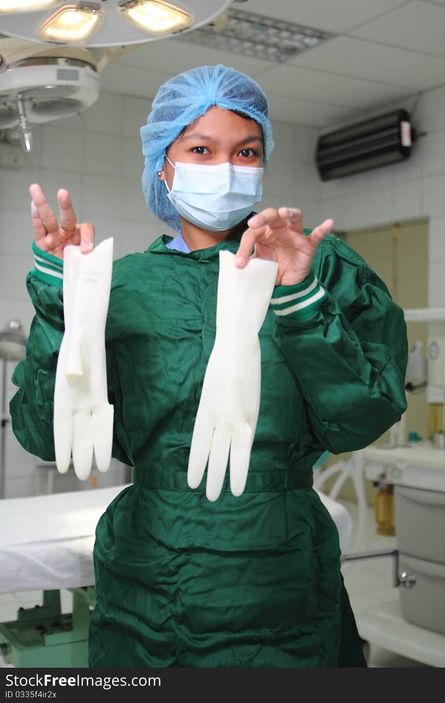 Female nurse showing surgical gloves. Female nurse showing surgical gloves