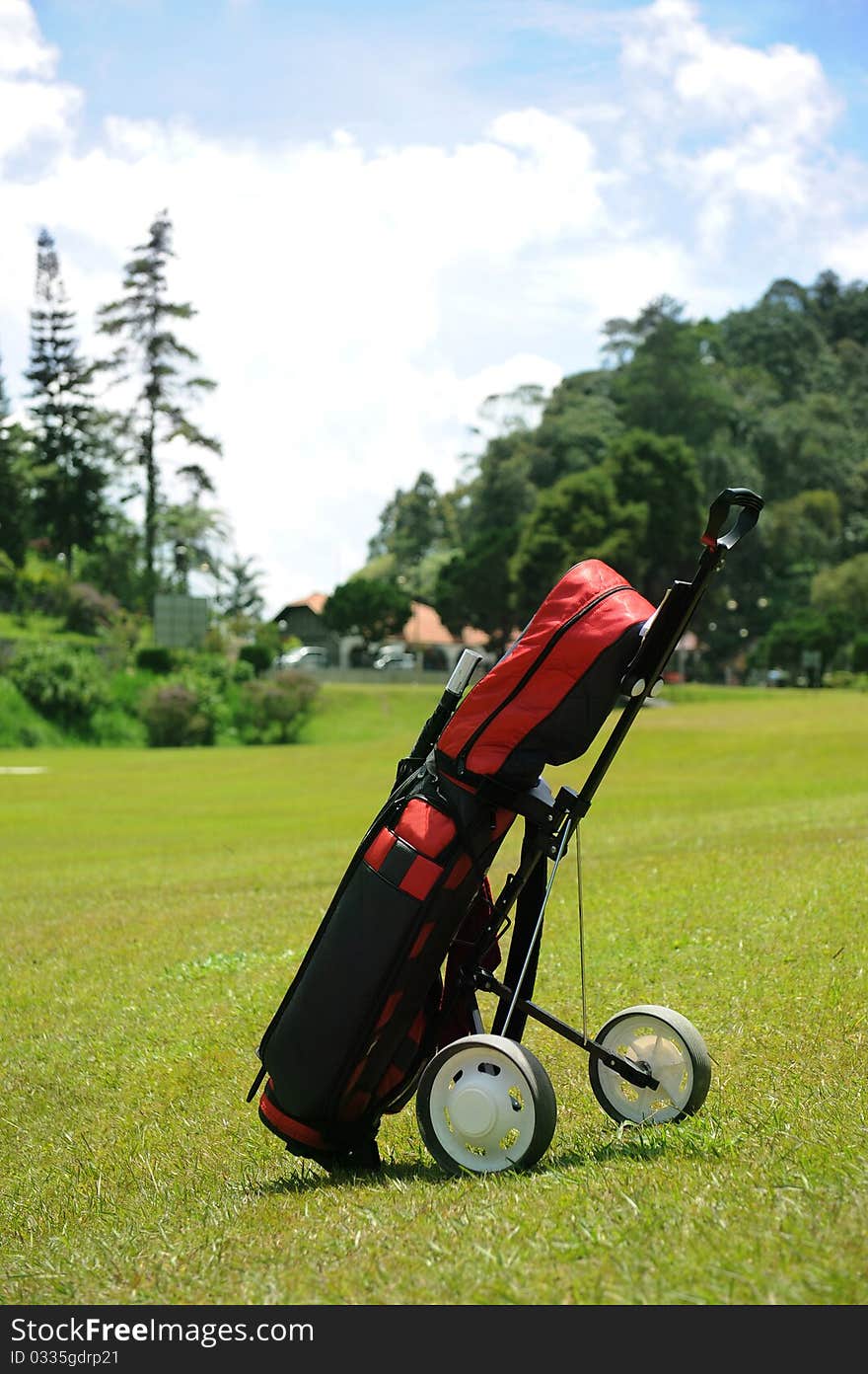 A golf set and trolley in golf course. A golf set and trolley in golf course.