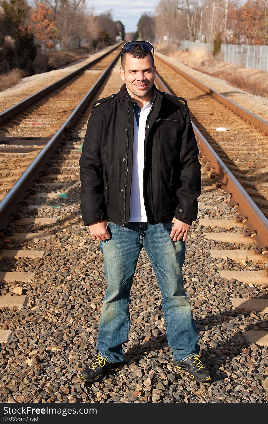 Portrait of a tourist on vacation waiting for his train at the train station.