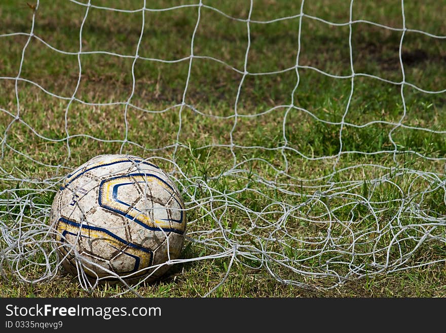 Old football in the goal