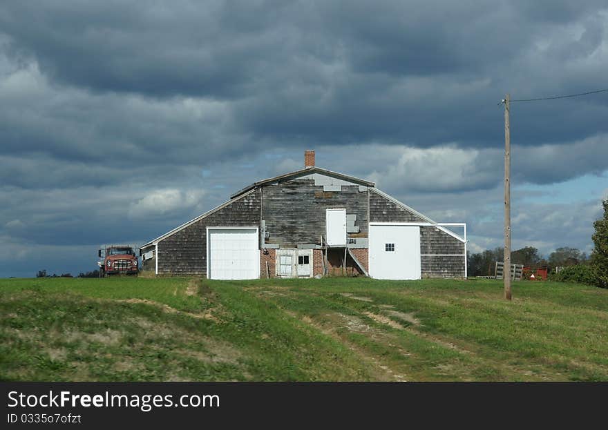 Barn and old truck on Long Island under threatening skies. Barn and old truck on Long Island under threatening skies.