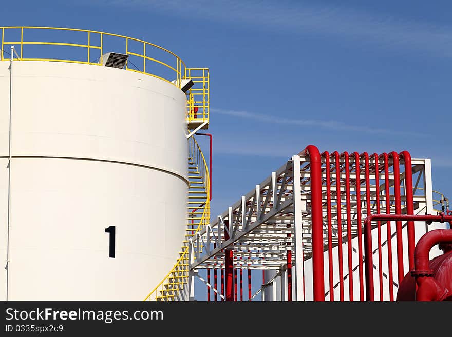 Metal storage tanks and blue sky