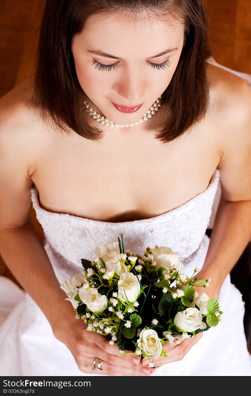 Beauty young woman in wedding dress with flowers