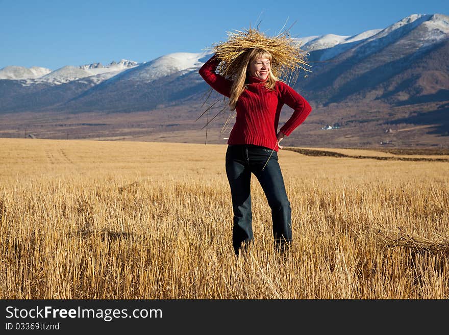 Beauty funny woman with straw on a head. Beauty funny woman with straw on a head