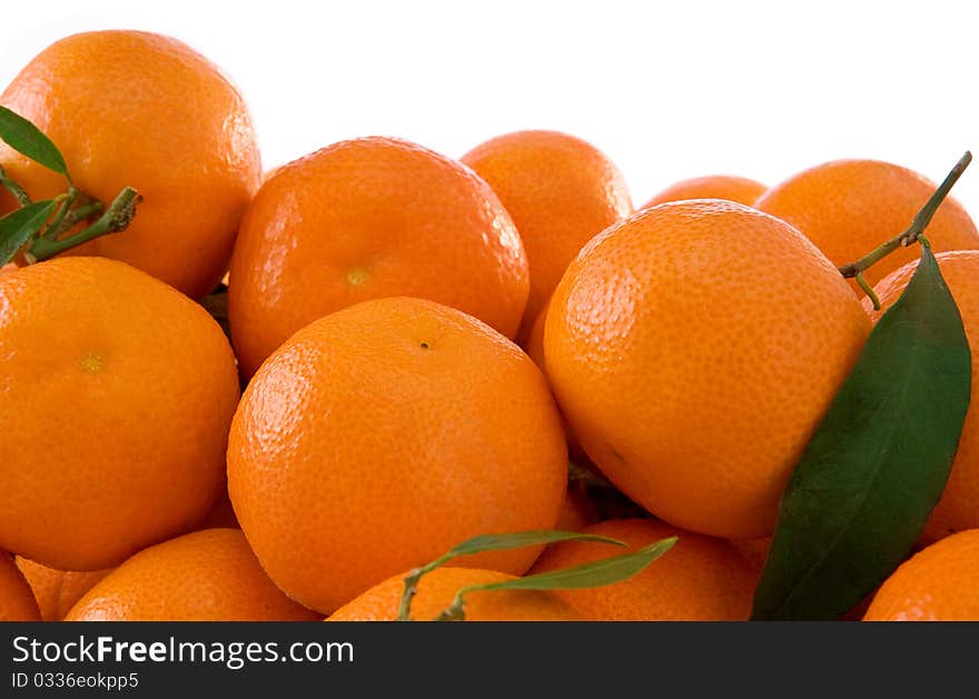 Tangerines And Green Leaves Isolated On White