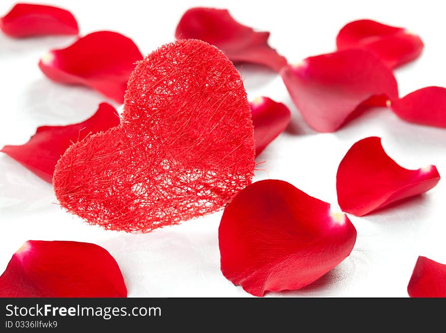 A red heart with rose petals for valentines day. A red heart with rose petals for valentines day