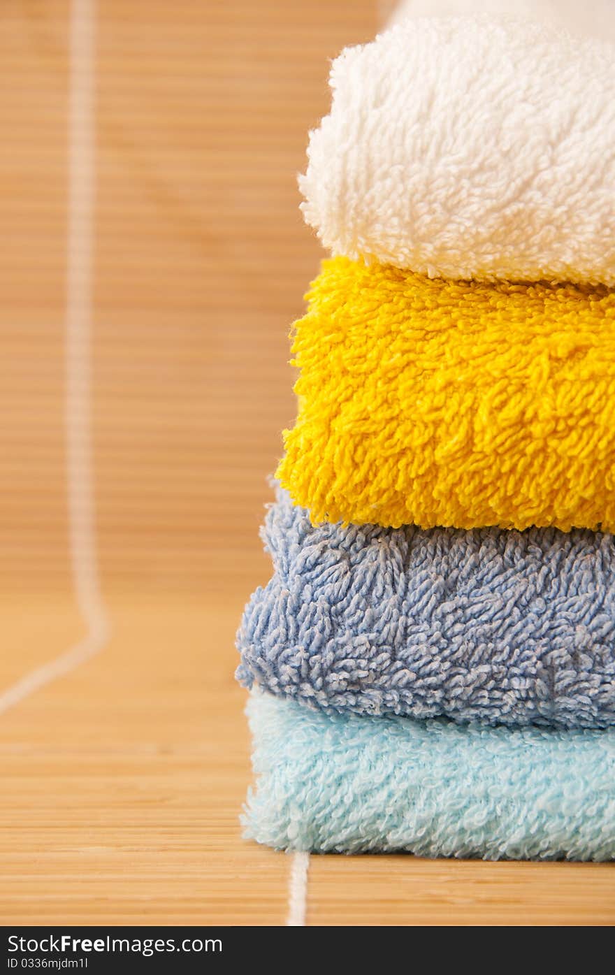 Colorful towels on a bamboo mat