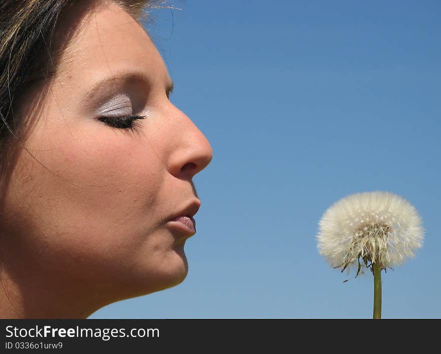 Portrait of a young girl with dandelion