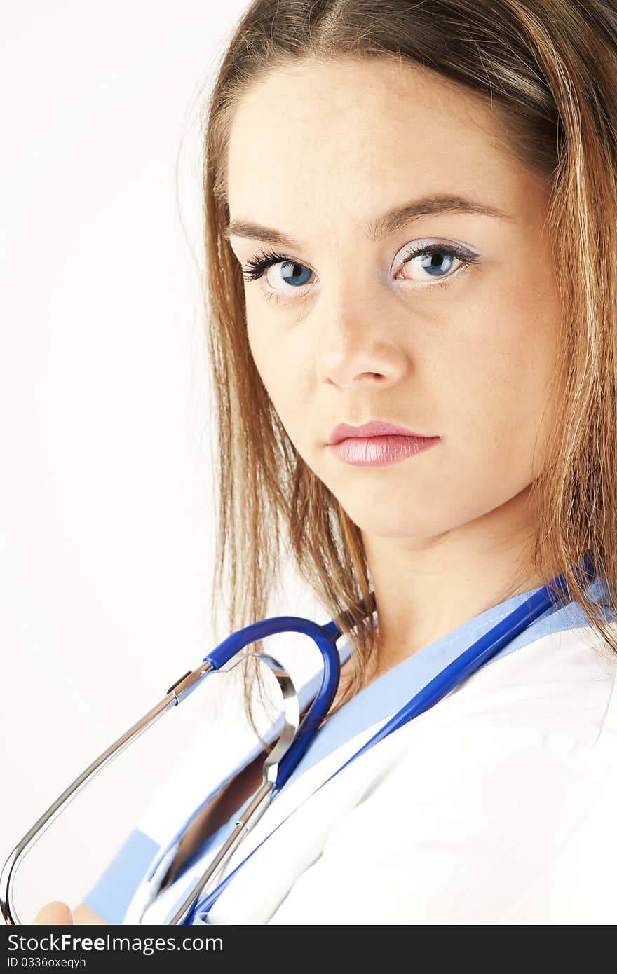 Young woman doctor or nurse holding wearing white and blue scrubs. Young woman doctor or nurse holding wearing white and blue scrubs