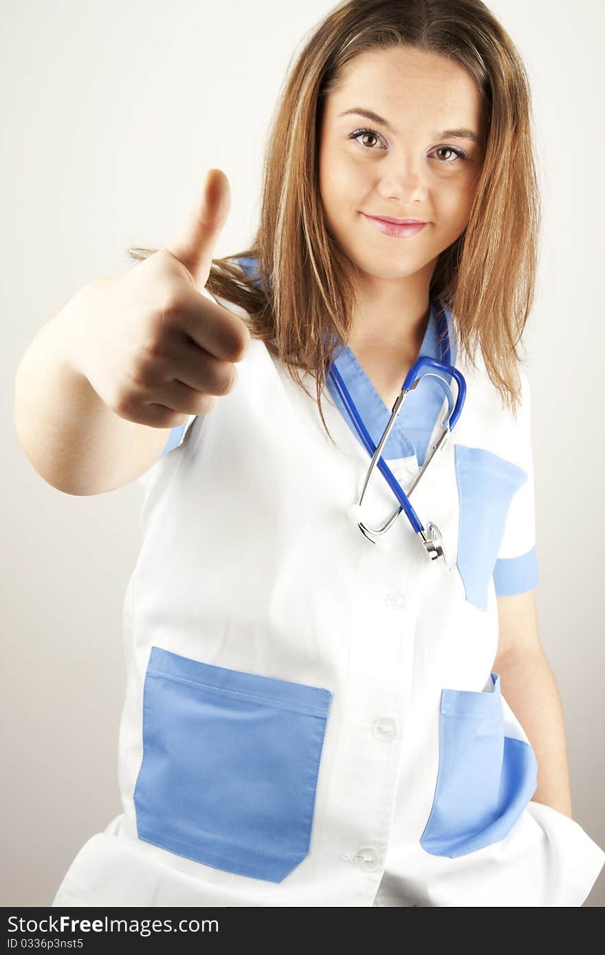 Young woman doctor or nurse holding wearing white and blue scrubs. Young woman doctor or nurse holding wearing white and blue scrubs