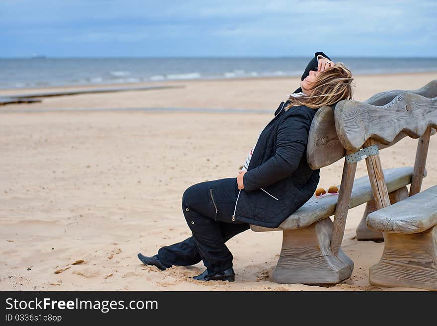 Mature woman relaxing at the Baltic sea in autumn day. Mature woman relaxing at the Baltic sea in autumn day.