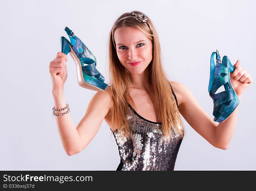 Pretty girl with shoes in hands