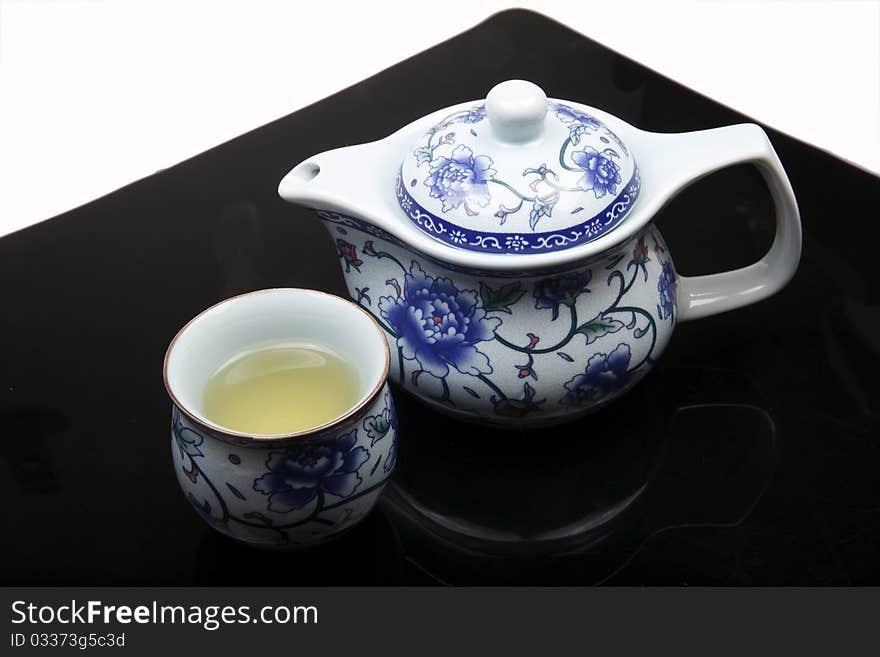 Chinese tea pot and cup on white-black background. (Jingdezhen Porcelain). Chinese tea pot and cup on white-black background. (Jingdezhen Porcelain)