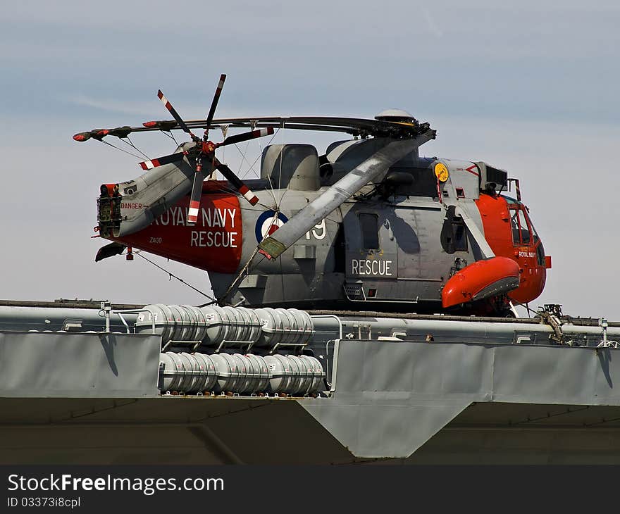 A shiny Royal Navy helicopter at rest on the Ark Royal at Liverpool. A shiny Royal Navy helicopter at rest on the Ark Royal at Liverpool