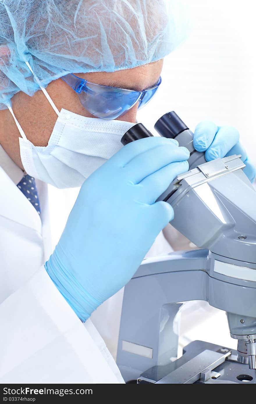 A scientist man working with microscope in laboratory