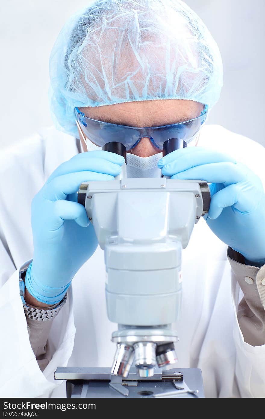 A scientist man working with microscope in laboratory