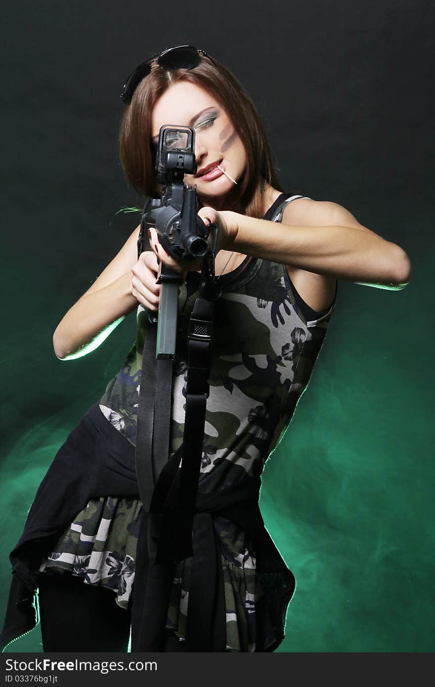 Attractive and sexy spy womanl with assault rifle in red