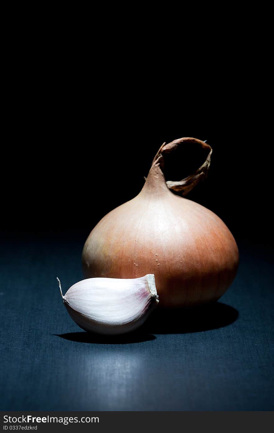 Onion And Garlic Clove On Black Background