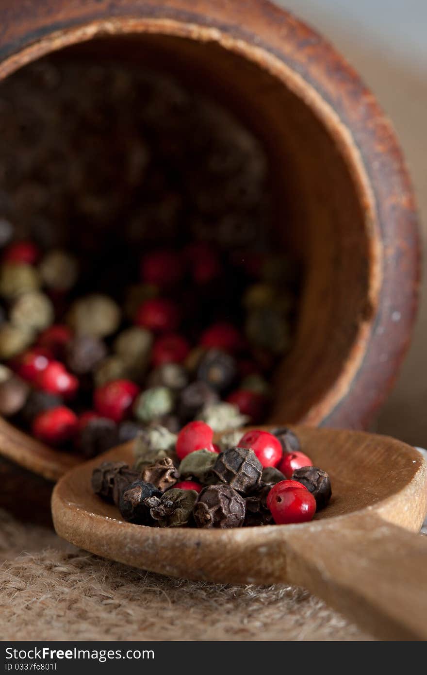 Wooden pestel and spoon with red, black, green, wh