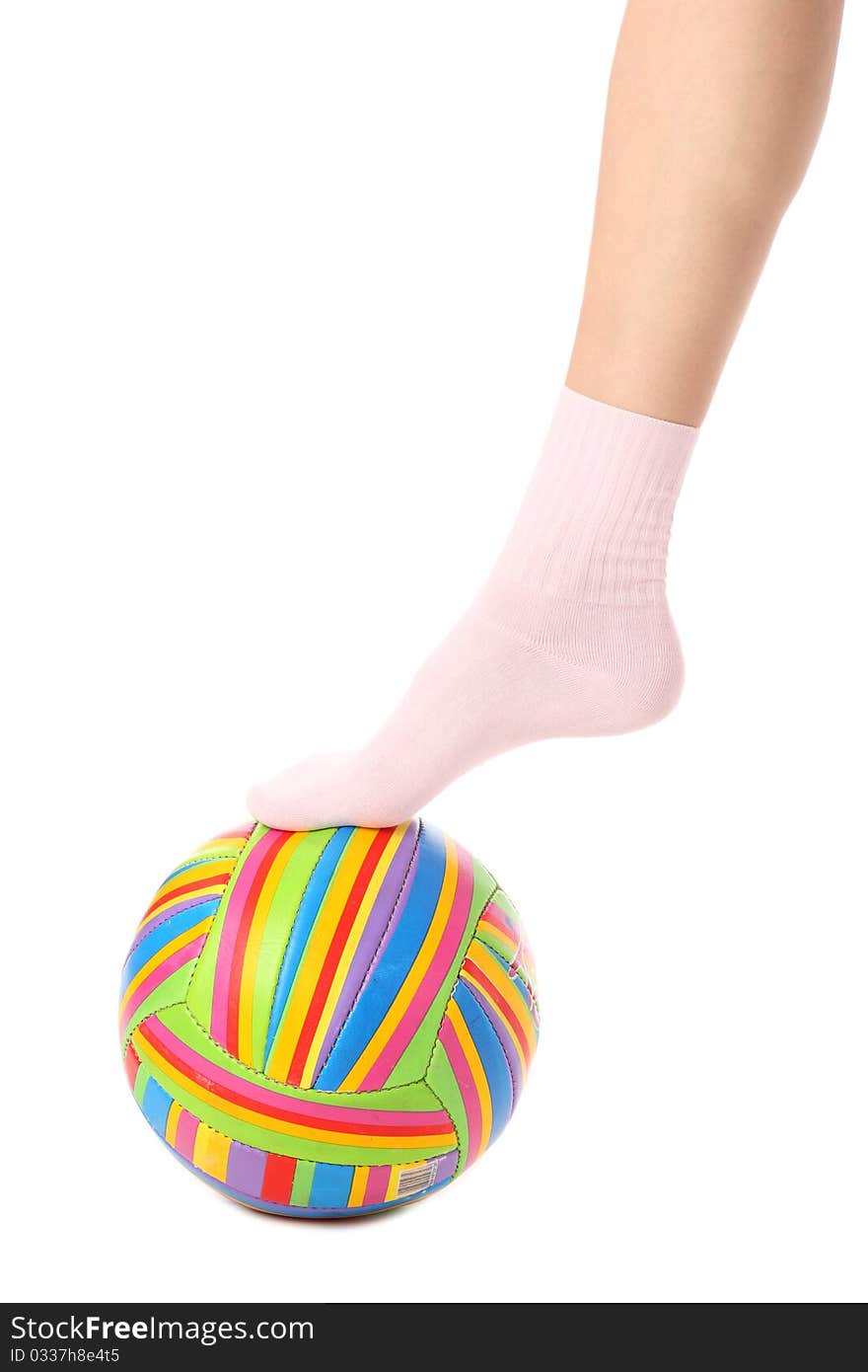 Close-up of human legs with a multicolored ball isolated on white