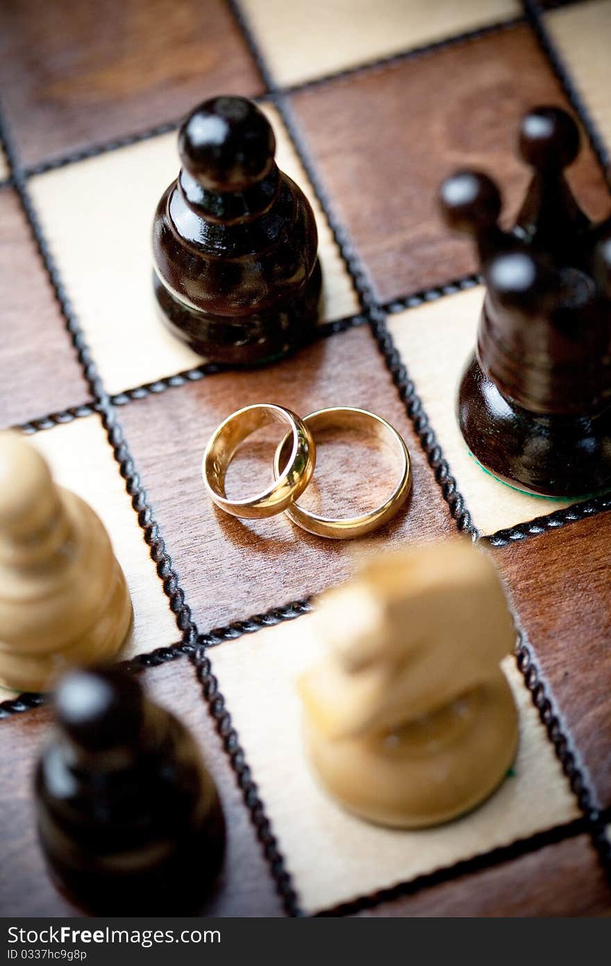 Wedding rings and chess, shallow DOF