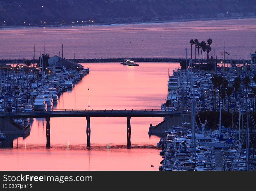 Reflections of sunrise presenting a pink light to be cast on the water. Reflections of sunrise presenting a pink light to be cast on the water.