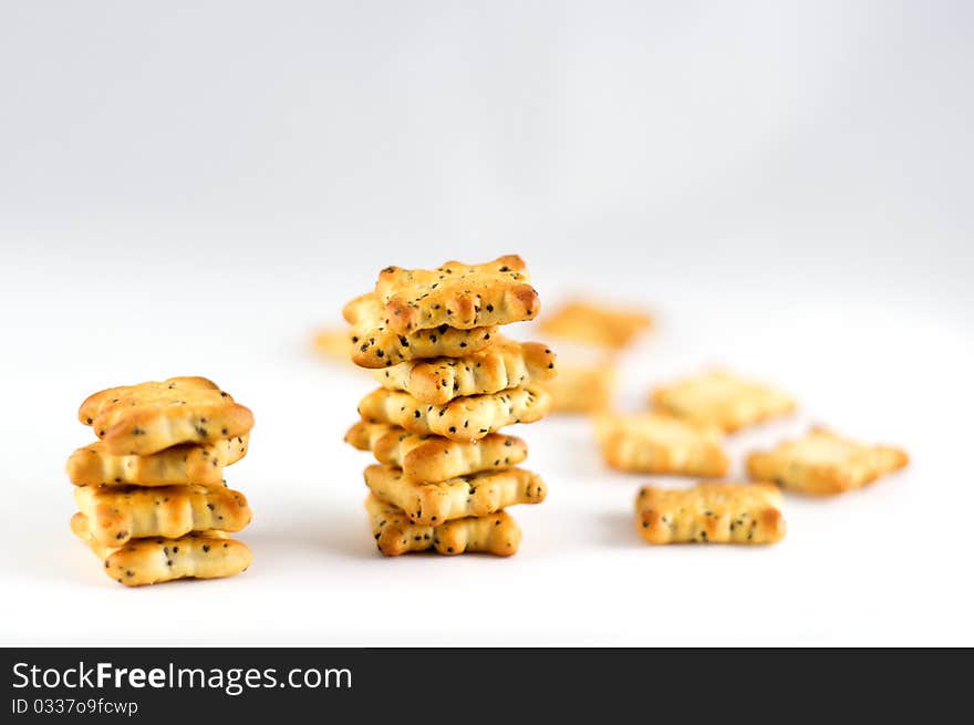 Crackers savory pastry with poppy seeds on a white background