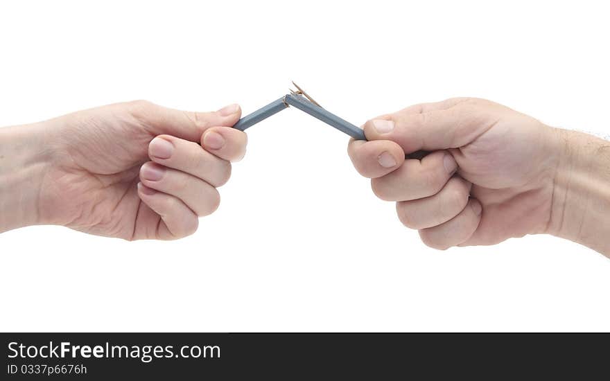 Female and male hands breaking wooden pencil. Female and male hands breaking wooden pencil