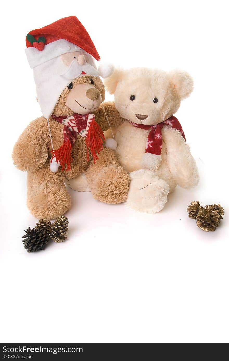 Two teddy bears shot in a christmas theme hi key style cuddling each other. Two teddy bears shot in a christmas theme hi key style cuddling each other