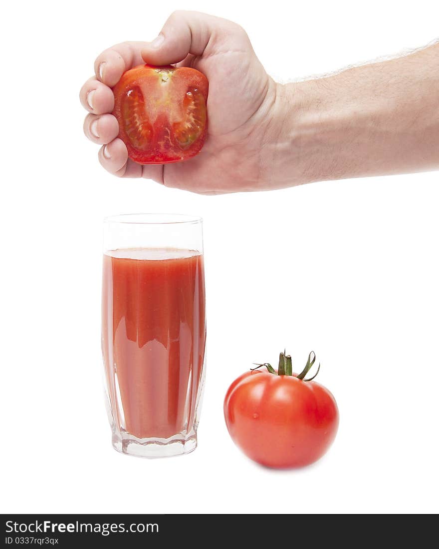 Juice from tomato in male hand on white