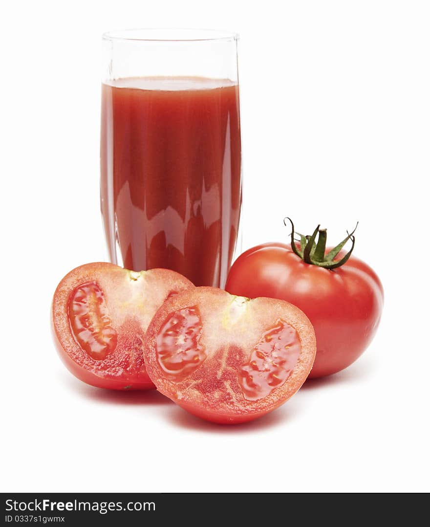 Fresh tomatoes and a glass full of tomato juice