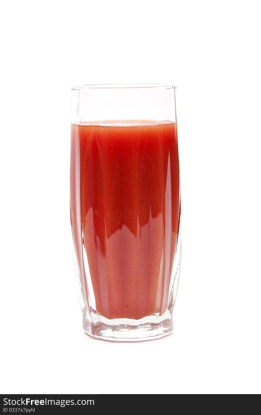 Tomato juice in clear glass isolated on white background.