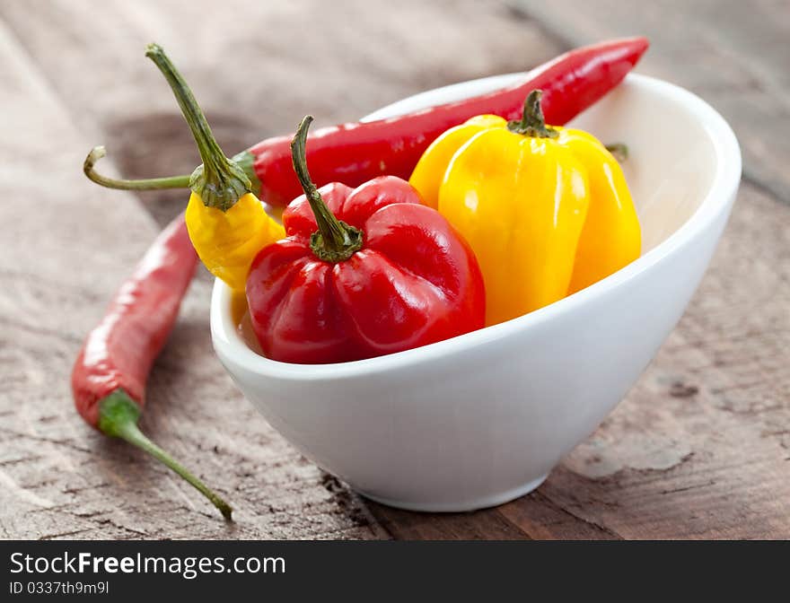 Fresh chili pepper and habanero in white bowl. Fresh chili pepper and habanero in white bowl