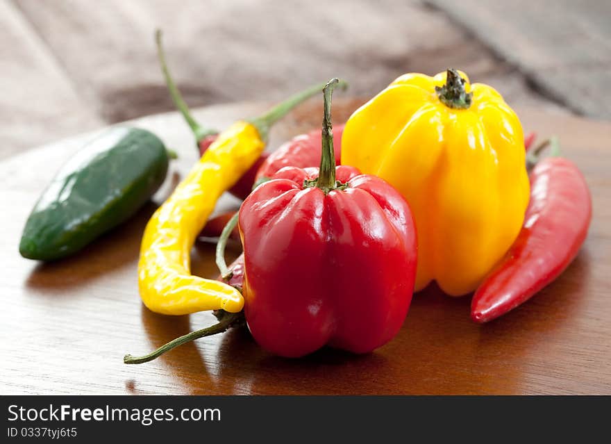 Mixed chillies on cutting board. Mixed chillies on cutting board