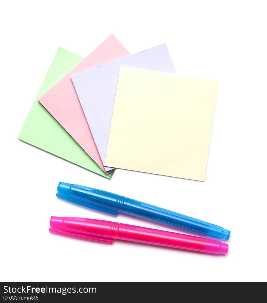 Stack of color notes and markers iisolated on white background