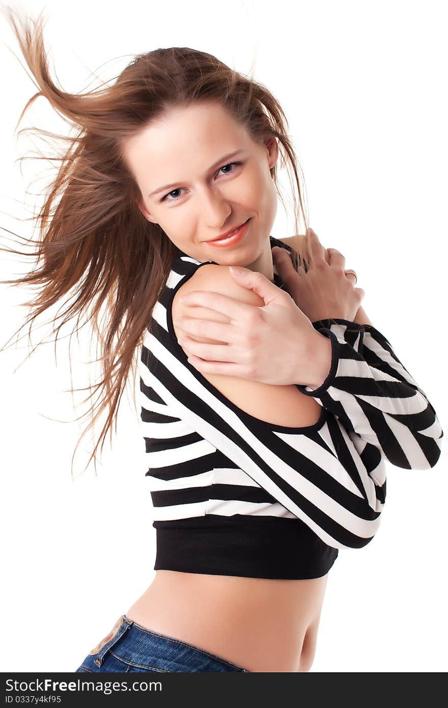 Bright young woman with streaming hair grabs herself on shoulders