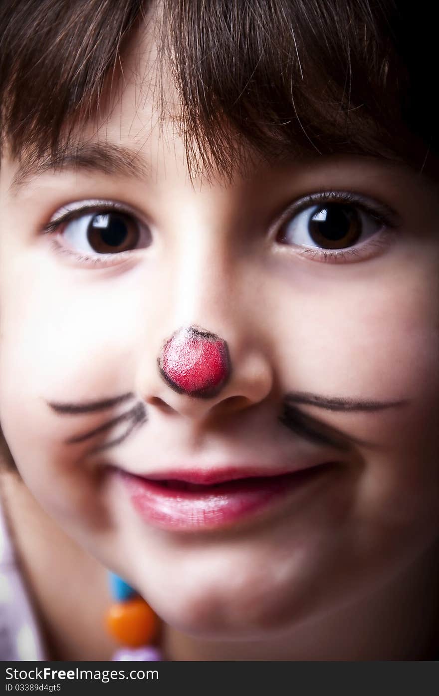 Close-up of little girl with a clown's nose. Close-up of little girl with a clown's nose