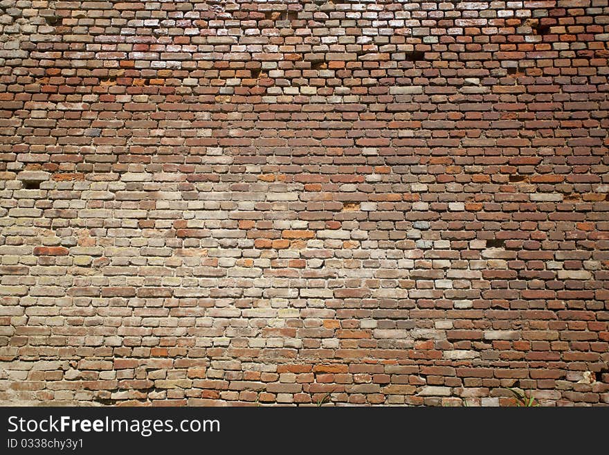 Broken and very old brick wall