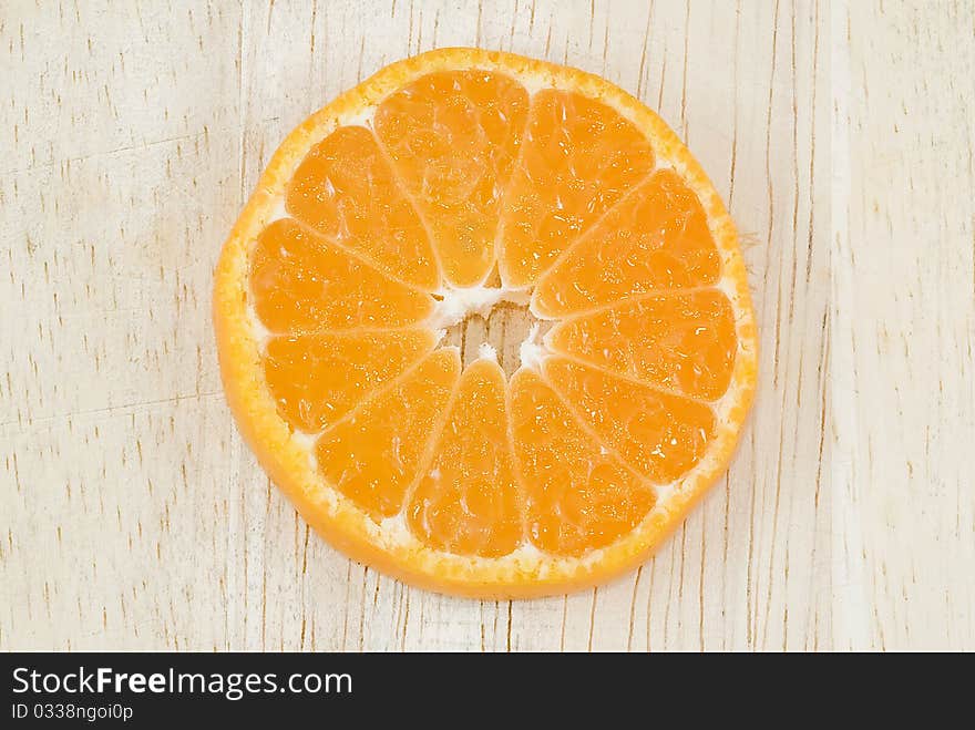 Orange slices on wood background