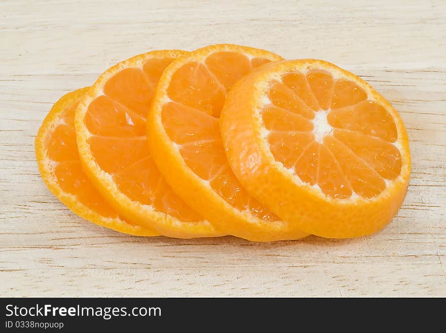 Orange slices on wood background